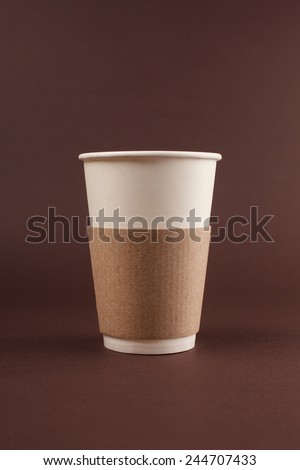 cup of coffee to go on brown backgrownd with place for text and logo