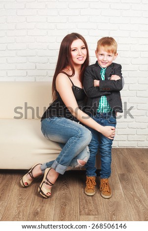Beautiful, happy pregnant woman with her elder son