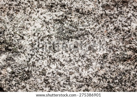 Gray granite stone texture or background, close up
