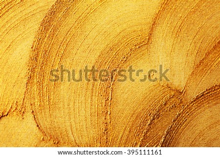 Golden shining stroke texture made with brush and paint hand drawn. Golden abstract background. Place for text.