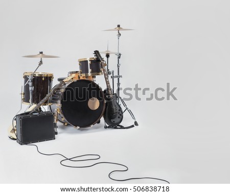 Rock Band, solo guitar, bass, drums, microphone on a black suitcase. Space for text