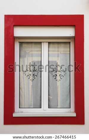 White traditional window with red frame