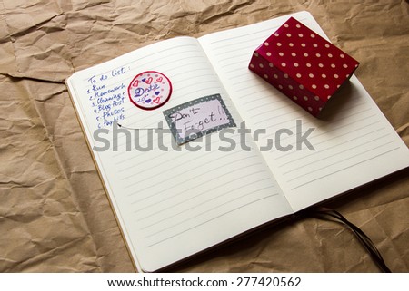 Opened notebook with to do list and stickers. With shallow depth of field.