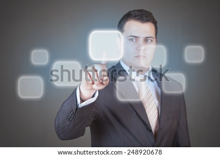 Handsome businessman pressing high tech (modern) button touch interface (virtual) - with place for logo, text or product