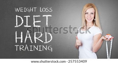 Healthy eating - Weight loss diet - Beautiful pretty young woman with fruit and measuring tape - isolated on old grey wall background with WEIGHT LOSS DIET HARD TRAINING text