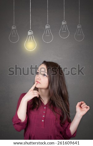 Beautiful young and pretty woman thinking (have no idea) in front of light idea bulbs concept