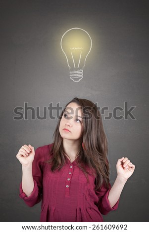 Beautiful young and pretty woman thinking (have no idea) in front of light idea bulb concept