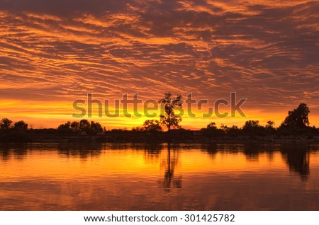Summer evening. Sunset on the river. The sun set over the horizon (river Desna. Ukraine)