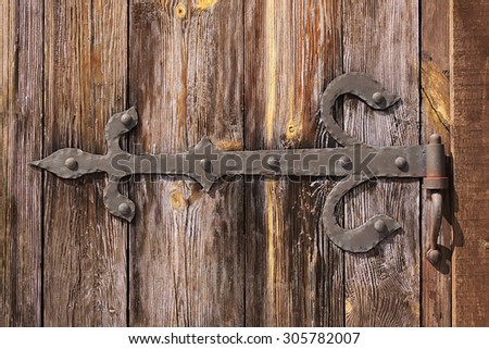 Old wooden door with door hinge.