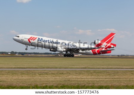 AMSTERDAM, THE NETHERLANDS - AUGUST 23: An Martinair Cargo MD11 takes off at Schiphol Airport on August 23, 2013. Martinair Cargo on their daily flight to Dubai