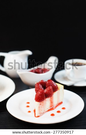 cheesecake with strawberries on a black background