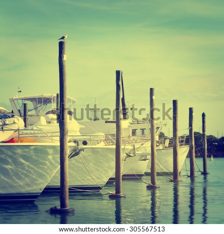 Vintage photo of sailing boats moored at marina. Selective focus. Grain. Toned