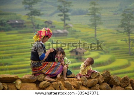 Family tribal mother and children girl smile in rice terraces background,Tu Lu Yen Bai, Vietnam.