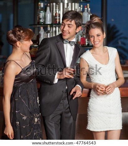 Three young people at a bar, men in 