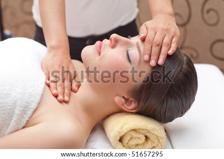 Beautiful young woman receiving head massage, shallow depth of field