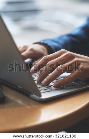 Close up shot of hands typing on laptop