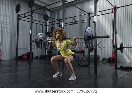 Girl doing squats at the gym