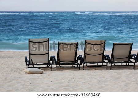 chairs on beach. Lounge chairs on each of