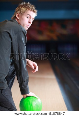 Portrait of young man prepared on bowling lane