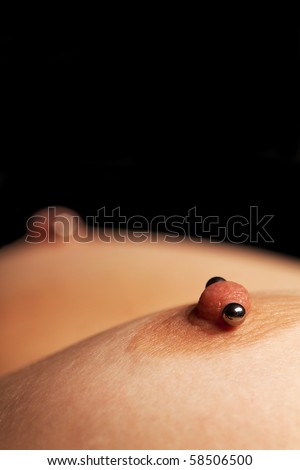 stock photo : Close-up view on woman pierced nipples, with copyspace on 