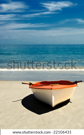 Row boat on the beach of an island paradise ready for a journey.
