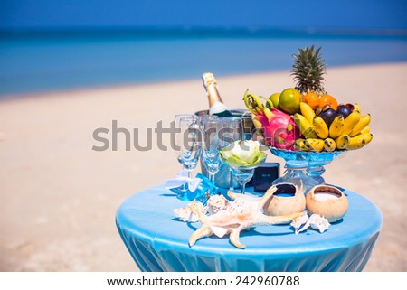 Wedding ceremony on the beach beautiful expensive decorations decor rings table with fruit and champagne on the beach arch