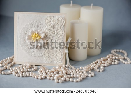 handmade cards and pearl necklace on a blue background