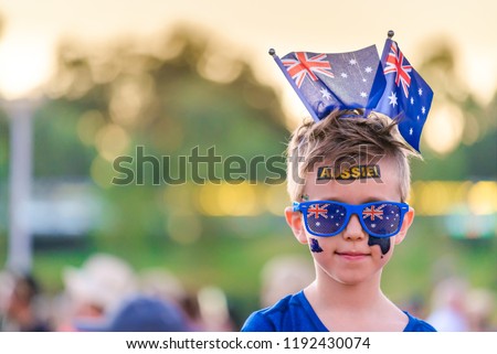 Cute Australian boy with flags and tattoos on his face on Australia Day