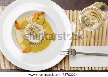 Shrimps with sauce, white rice and lime on simple white plate