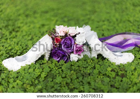 purple wedding flowers and bridal shoes