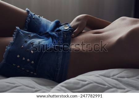 closeup of women abdomen and flat tummy. sexy body in texas shorts