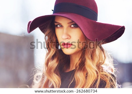 beautiful fashionable woman wearing hat and coat