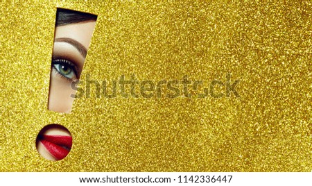 The girl says - attention A girl with beautiful puffy lips, painted in red lipstick with a metallic effect. Lips in the pit in the form of an exclamation mark of golden shiny paper.