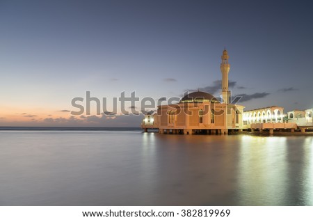Ar Rahmah Mosque by the Red Sea, Jeddah, Saudi Arabia. Taken during sunset with slow shutter speed. Motion blur due to long exposure. Caption space area.