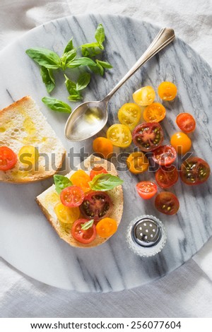 Bruschetta with a Mix of Red, Orange and Yellow Cherry Tomatoes