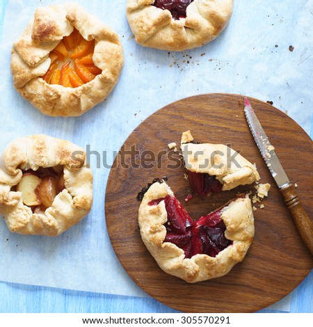 Closeup of homemade plum pie and other fruit pies