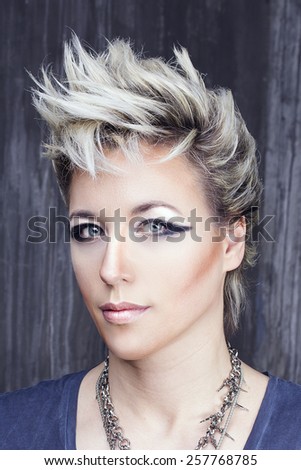 Beauty women portrait in punk rock style with dark makeup and hair style