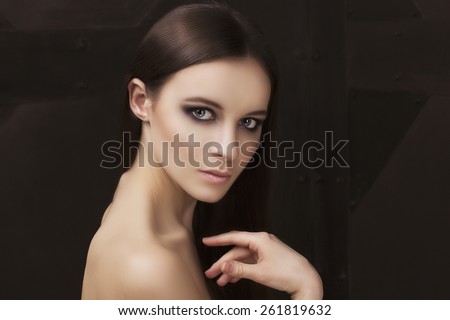 Beauty shooting natural face model with smoky eyes makeup and hair style