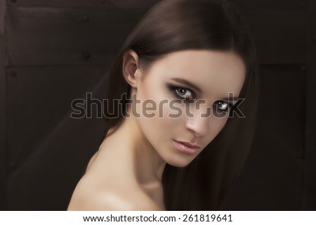 Beauty shooting natural face model with smoky eyes makeup and hair style