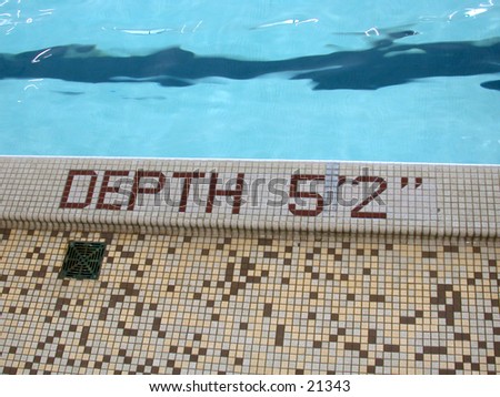 Side of pool, with depth marker inset with tiles to state Depth 5 foot 2 inches
