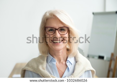 Smiling attractive senior businesswoman wearing glasses head shot, happy aged teacher, successful woman company boss, older female executive, mature lady professional looking at camera, portrait