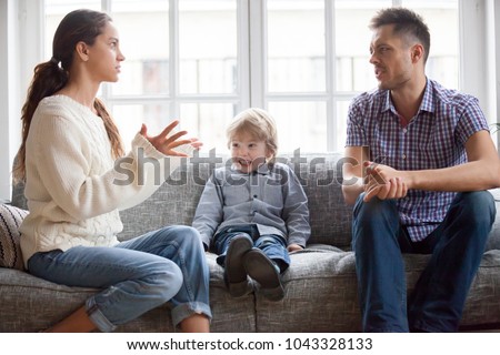 Frustrated little boy son scared with mom and dad fighting at home, sad stressed child suffers from parents argument or divorce causing mental psychological trauma, family conflicts hurt kid concept