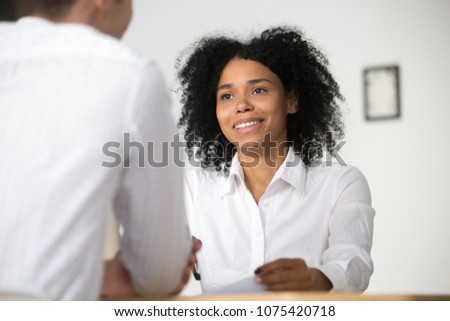 Smiling african female hr employer interviewing male job applicant asking questions, black recruiter attentively listening to seeker, good first impression, human resources management concept