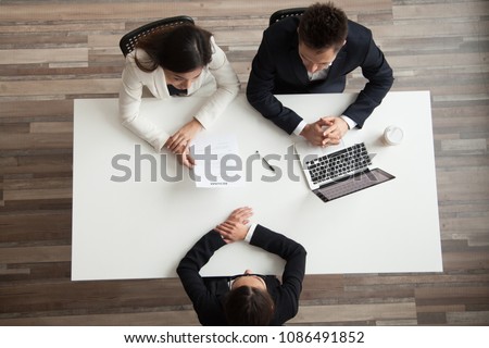 Hr managers interviewing female job applicant, recruiters listen to candidate answering questions at hiring negotiations, recruiting and staffing, making first impression concept, top view from above