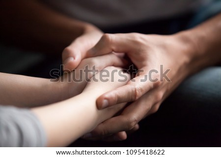 Male hands holding female, caring loving understanding man showing comfort and empathy, giving psychological support to woman in marriage relationships concept, couple reconciliation, close up view