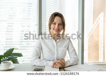 Successful businesswoman looking at camera recording video blog or vlog in office, confident business coach speaker talking for video call, webinar, job interview, online training, headshot portrait