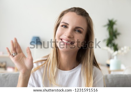 Happy friendly woman waving hand looking at camera webcam, smiling millennial lady vlogger recording vlog or making video call at home, lifestyle vlogging, dating online concept, headshot portrait