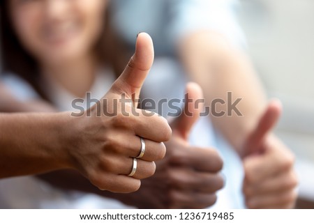 Happy multiethnic friends showing thumbs up close up, like, finger, gesture, recommendation of good choice, excited satisfied clients, successful teamwork, hands view, celebrate great deal