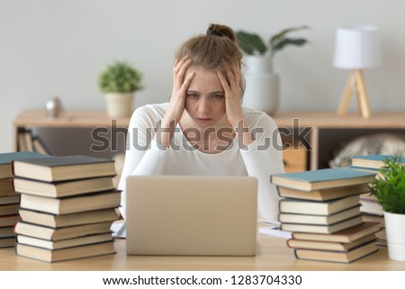 Stressed college student tired of hard learning with books and laptop in exams tests preparation, overwhelmed high school teen girl exhausted with difficult studies or too much homework, cram concept