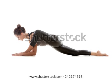 Sporty yoga girl on white background exercises, the left knee is bent over the left ankle